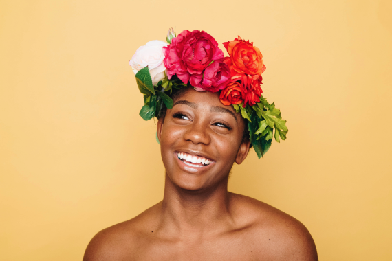 Woman laughs on her head with a wreath of flowers